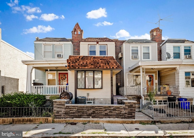 townhome / multi-family property featuring covered porch and cooling unit