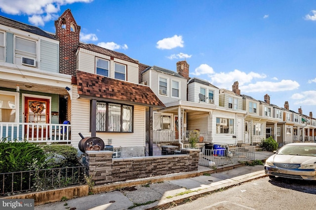 townhome / multi-family property featuring covered porch