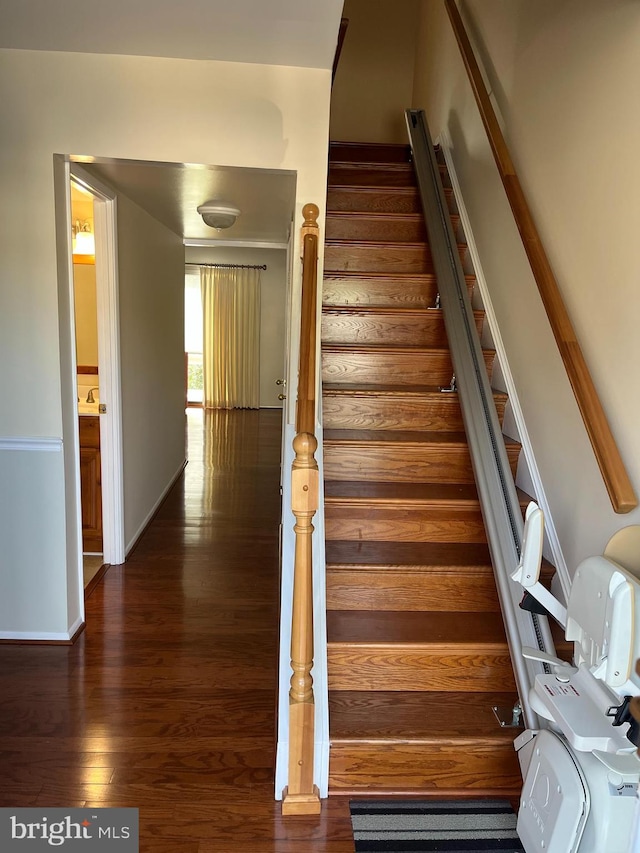 stairs featuring wood-type flooring