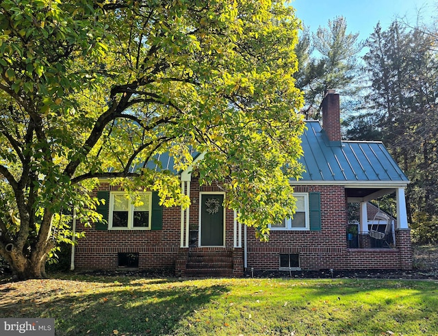 view of property hidden behind natural elements featuring a front lawn