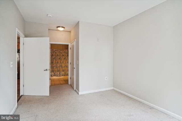 unfurnished bedroom with light colored carpet