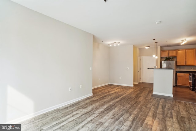 unfurnished living room with dark hardwood / wood-style floors