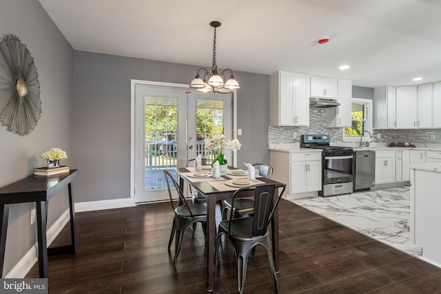 dining room with french doors, a notable chandelier, and dark hardwood / wood-style flooring