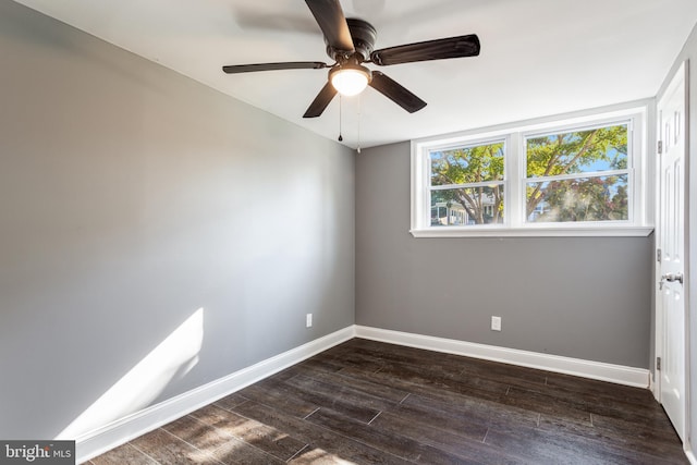 empty room featuring dark wood-type flooring and ceiling fan