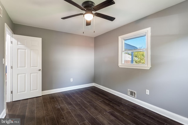 unfurnished room with dark wood-type flooring and ceiling fan