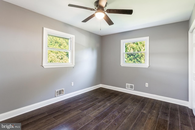 spare room featuring dark wood-type flooring and ceiling fan