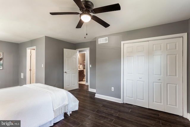 bedroom with dark hardwood / wood-style flooring, a closet, and ceiling fan