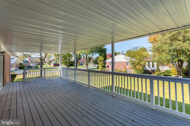 wooden terrace with a lawn