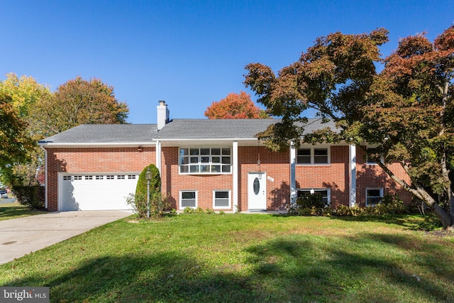 bi-level home featuring a front lawn and a garage