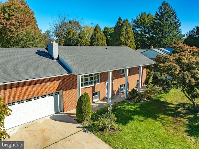 view of front of property with a front lawn and a garage