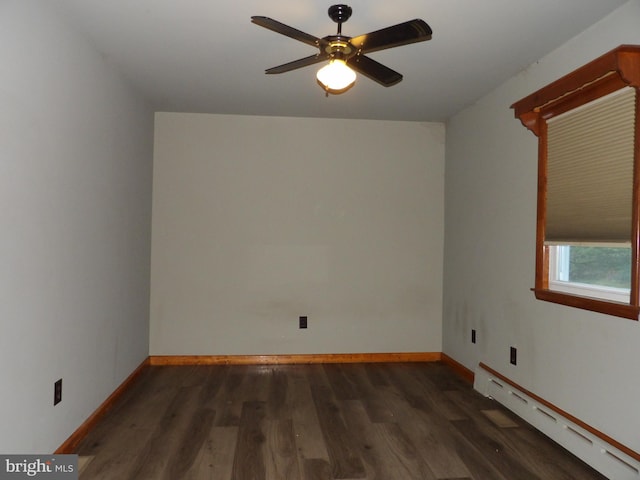 unfurnished room with a baseboard heating unit, ceiling fan, and dark hardwood / wood-style flooring