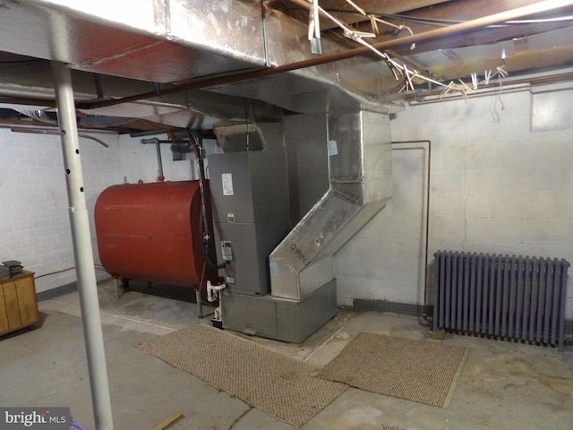 basement featuring radiator and heating unit