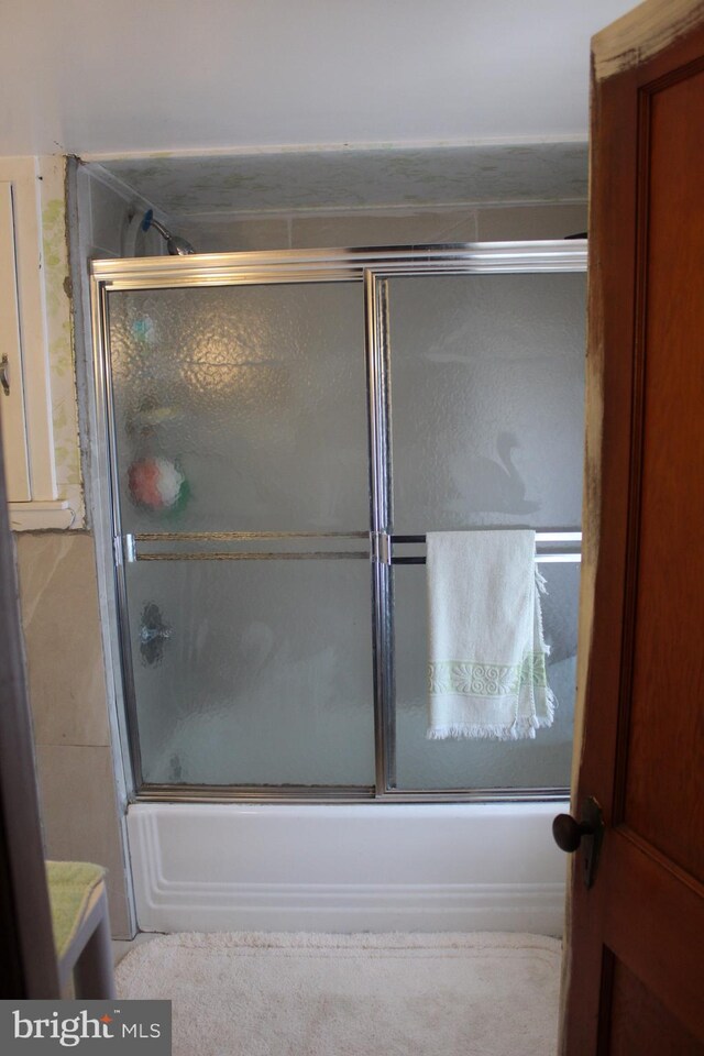 bathroom with vanity and shower / bath combination with glass door