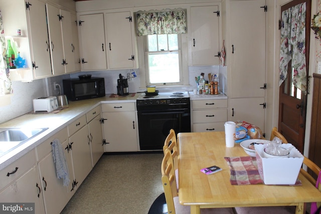 kitchen featuring white cabinets, black appliances, and backsplash