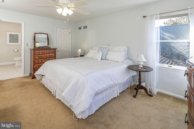 carpeted bedroom featuring connected bathroom, a closet, and ceiling fan