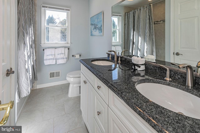 bathroom with vanity, toilet, tile patterned floors, and a shower with curtain