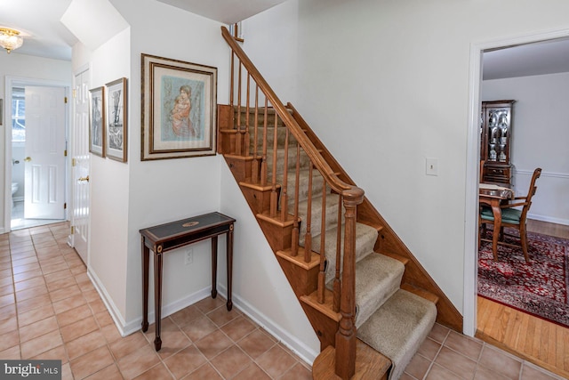 stairs featuring tile patterned flooring