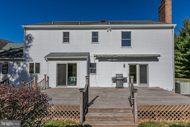 rear view of property featuring cooling unit and a deck