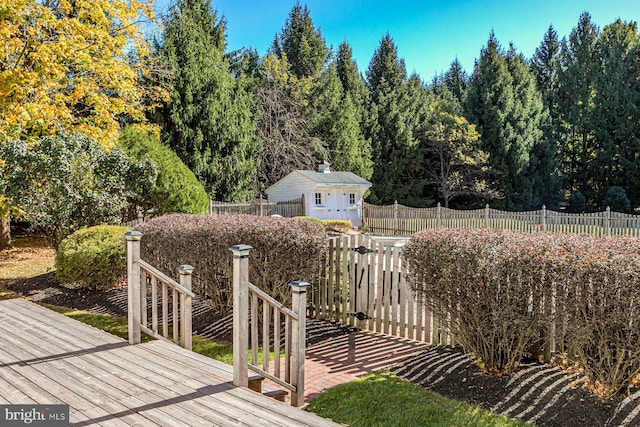 wooden terrace featuring an outdoor structure