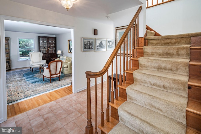 stairs with wood-type flooring