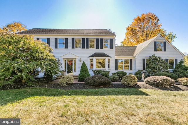 colonial home with a front lawn