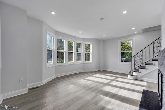 unfurnished living room featuring light hardwood / wood-style flooring