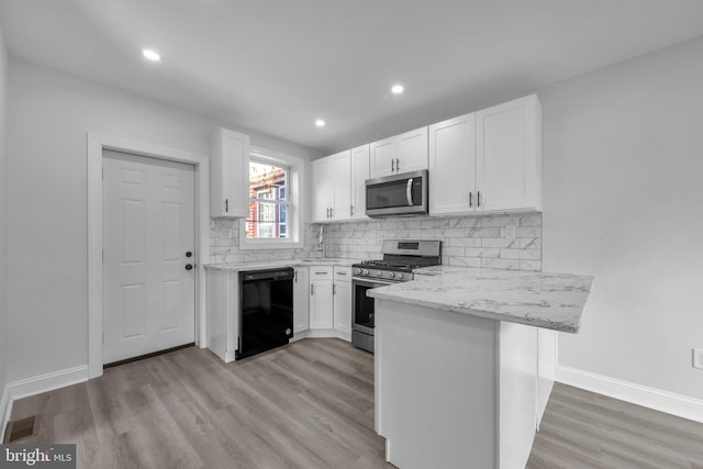 kitchen featuring white cabinets, stainless steel appliances, and light hardwood / wood-style floors