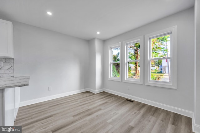 unfurnished living room with light hardwood / wood-style floors