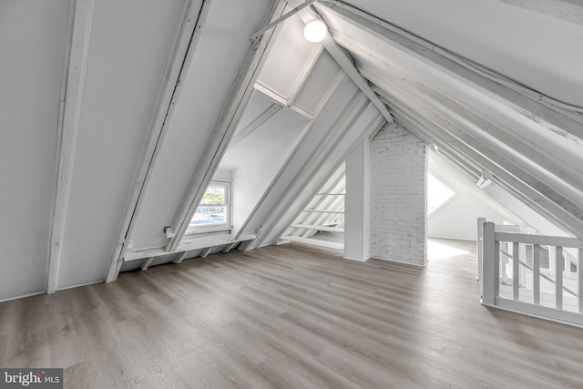 bonus room featuring light hardwood / wood-style flooring and vaulted ceiling