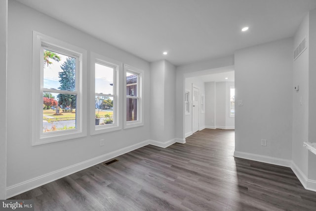 empty room with dark hardwood / wood-style flooring