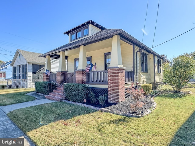 view of front facade with a porch and a front lawn