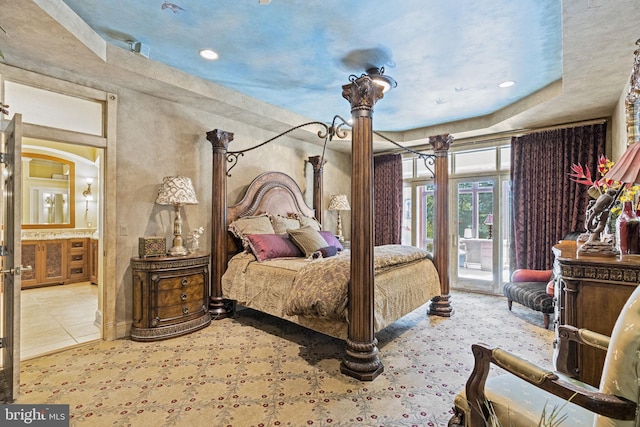 bedroom featuring recessed lighting, ensuite bath, and access to exterior