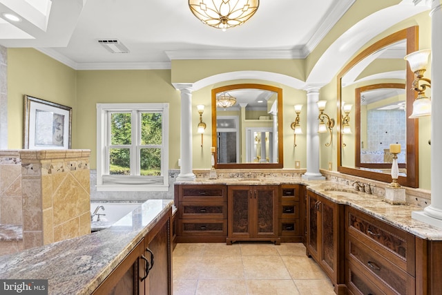 bathroom featuring ornate columns, vanity, a bathtub, ornamental molding, and tile patterned flooring