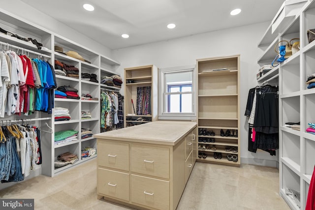 walk in closet with light colored carpet