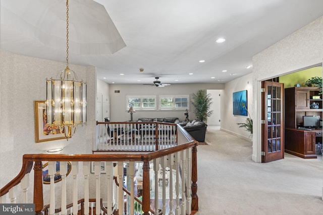 corridor with baseboards, recessed lighting, a notable chandelier, and carpet