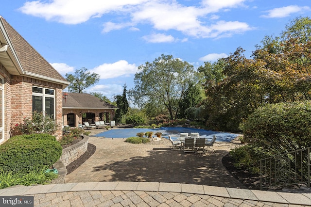 view of pool featuring a patio and outdoor dining space