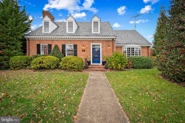 110 E Northern Pkwy, Baltimore, MD 21212 - cape cod home with a chimney, a front yard, and brick siding