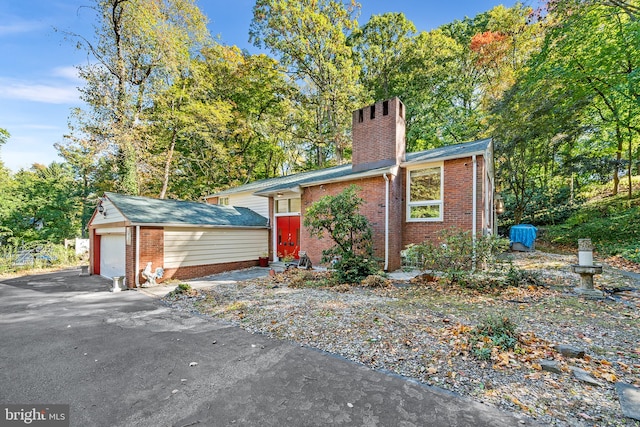 view of front of house with an outdoor structure and a garage