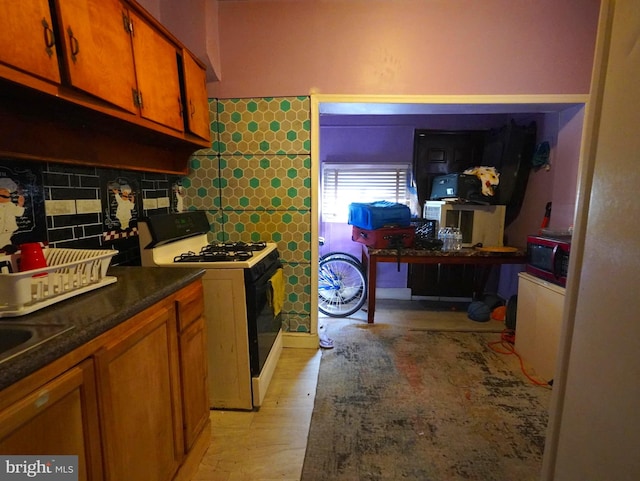 kitchen with light hardwood / wood-style floors and white range with gas cooktop