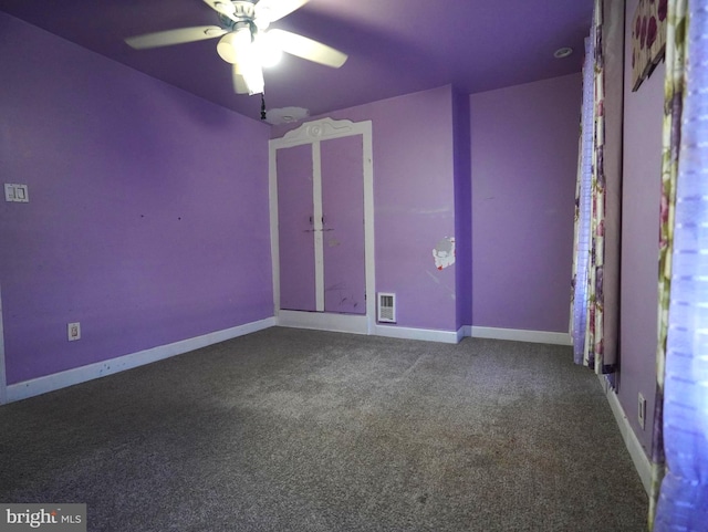 spare room featuring carpet flooring and ceiling fan