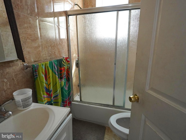 full bathroom featuring vanity, combined bath / shower with glass door, and toilet