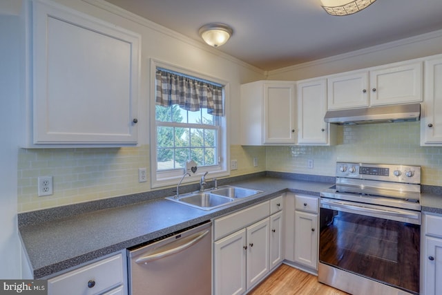 kitchen with light hardwood / wood-style floors, white cabinetry, stainless steel appliances, and sink