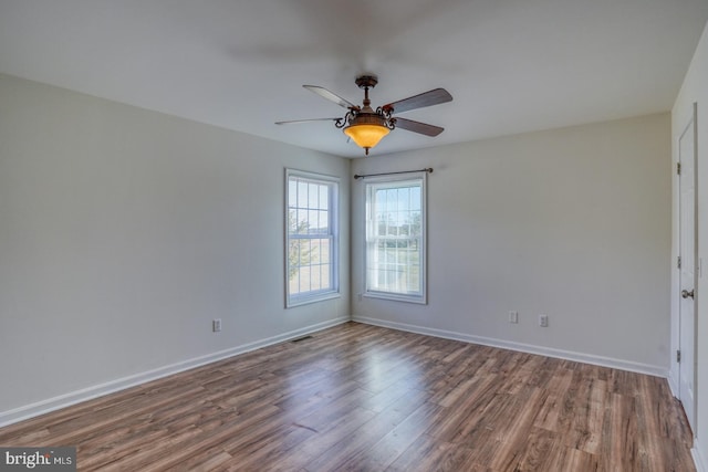 empty room with wood-type flooring and ceiling fan