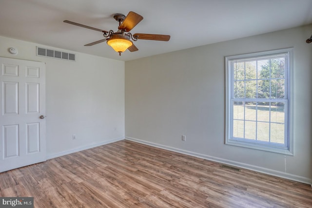 spare room featuring light wood-type flooring and ceiling fan