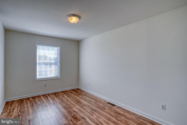 spare room with light hardwood / wood-style flooring