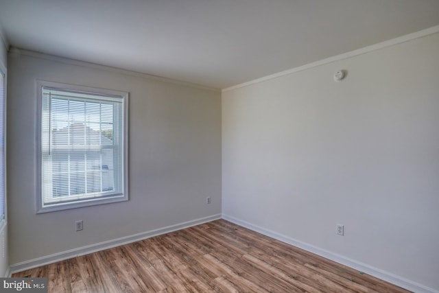 unfurnished room featuring crown molding and hardwood / wood-style flooring