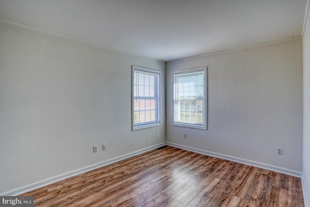 unfurnished room featuring light hardwood / wood-style flooring and ornamental molding