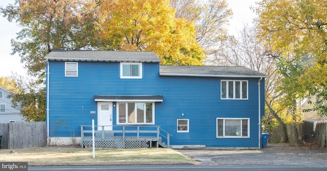 1019 Green Ln, Levittown, PA 19057 - view of front of house featuring a wooden deck, roof with shingles, a front lawn, and fence