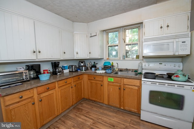 kitchen featuring light hardwood / wood-style flooring, sink, and white appliances