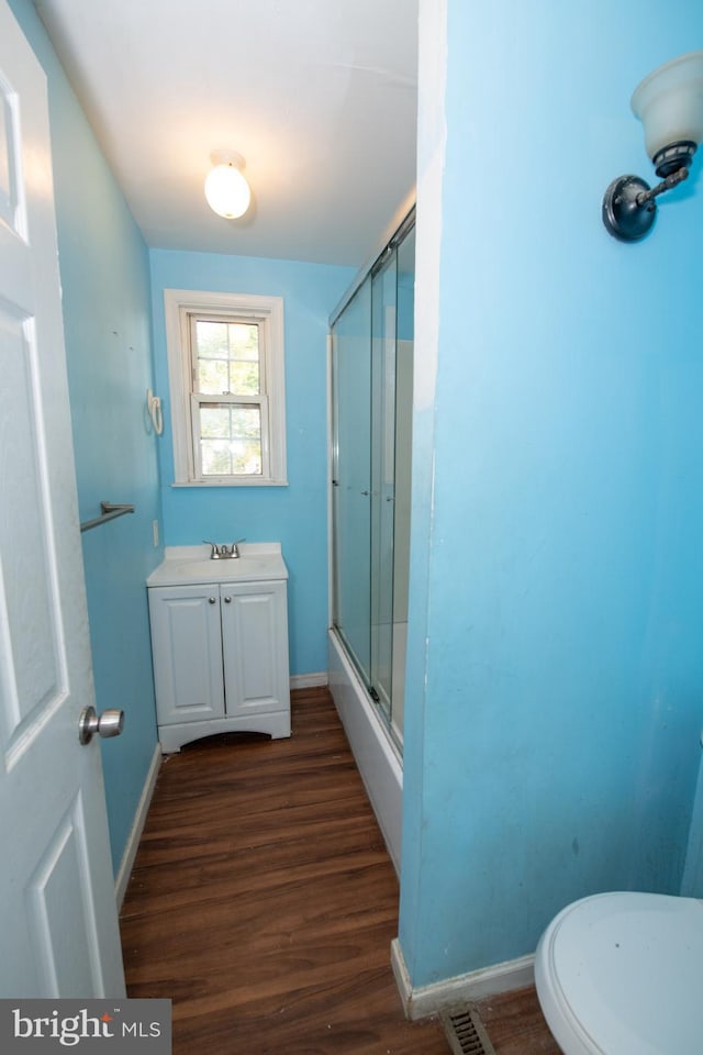1019 Green Ln, Levittown, PA 19057 - full bathroom with toilet, wood finished floors, vanity, visible vents, and baseboards